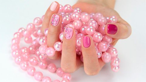 Pink gel polish nails with hand painted motifs